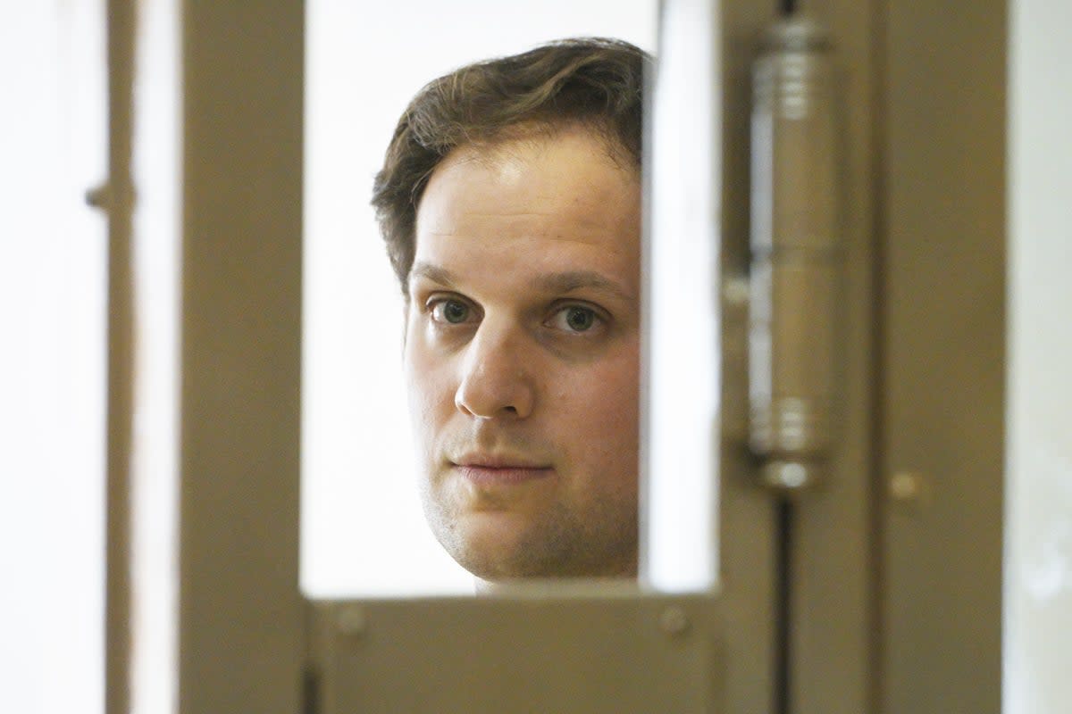 Wall Street Journal reporter Evan Gershkovich stands in a glass cage in a courtroom at the Moscow City Court in Moscow, on 22 June (Associated Press)