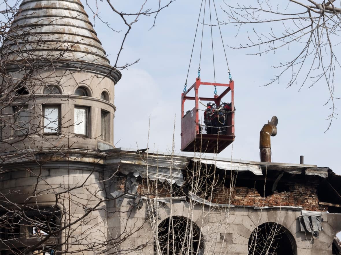 Firefighters are seen at the site of a deadly fire that broke out March 16, 2023, in Montreal. (Ryan Remiorz/The Canadian Press - image credit)