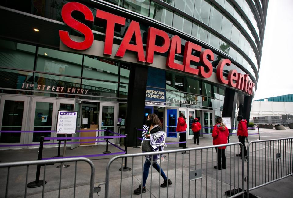 A Staples Center staffer picks up her new uniform