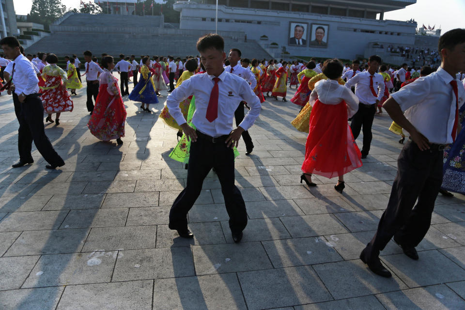 North Koreans take part in a mass dance during the commemoration of the 65th anniversary of the end of the Korean War, which the country celebrates as the day of "victory in the fatherland liberation war", at Kim Il Sung Square in Pyongyang, North Korea, Friday, July 27, 2018. (AP Photo/Dita Alangkara)