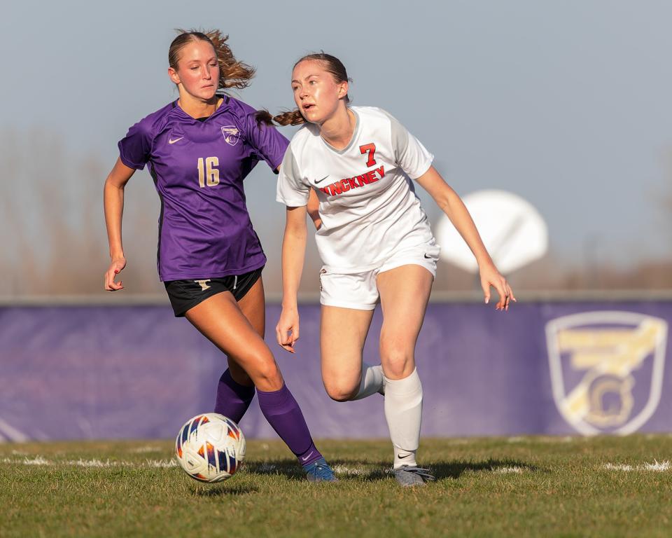 Pinckney's Alexis Altizer (7) and Fowlerville's Addie Borowy chase down a loose ball Monday, April 8 2024.