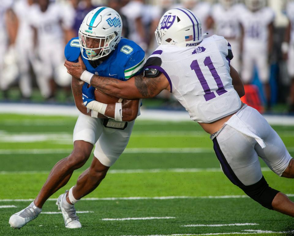 West Florida's John Jiles tries to get past Kentucky Wesleyan's Bryce Yeast during action against Kentucky Wesleyan at the University of West Florida Friday, September 1, 2023.