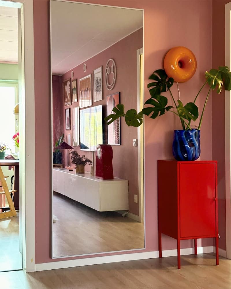 Donut-shaped sconce wall lights hang on the hallway walls.