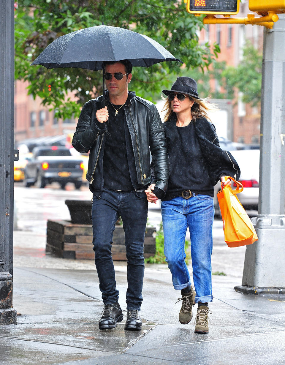 Justin Theroux and Jennifer Aniston walk in the rain in the West Village on September 20, 2011 in New York City.