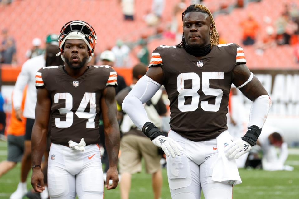 Browns running back Jerome Ford (34) and tight end David Njoku (85) walk from the field after losing to the New York Jets, Sunday, Sept. 18, 2022, in Cleveland.