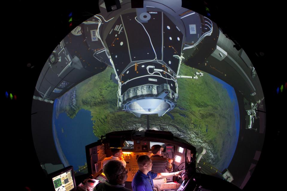 Flight crew practices rendezvous and docking with the International Space Station while being observed in a simulator at the Johnson Space Center on June 28, 2011, in Houston. (AP Photo/Smiley N. Pool - Houston Chronicle )