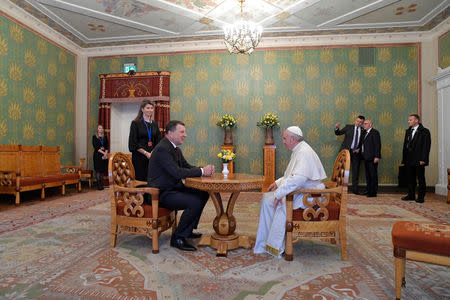 Pope Francis and Latvian President Raimonds Vejonis talk during a welcoming ceremony at the Presidential Palace in Riga, Latvia, during the second leg of Pope Francis' trip to the Baltic states September 24, 2018. Vatican Media/Handout via REUTERS