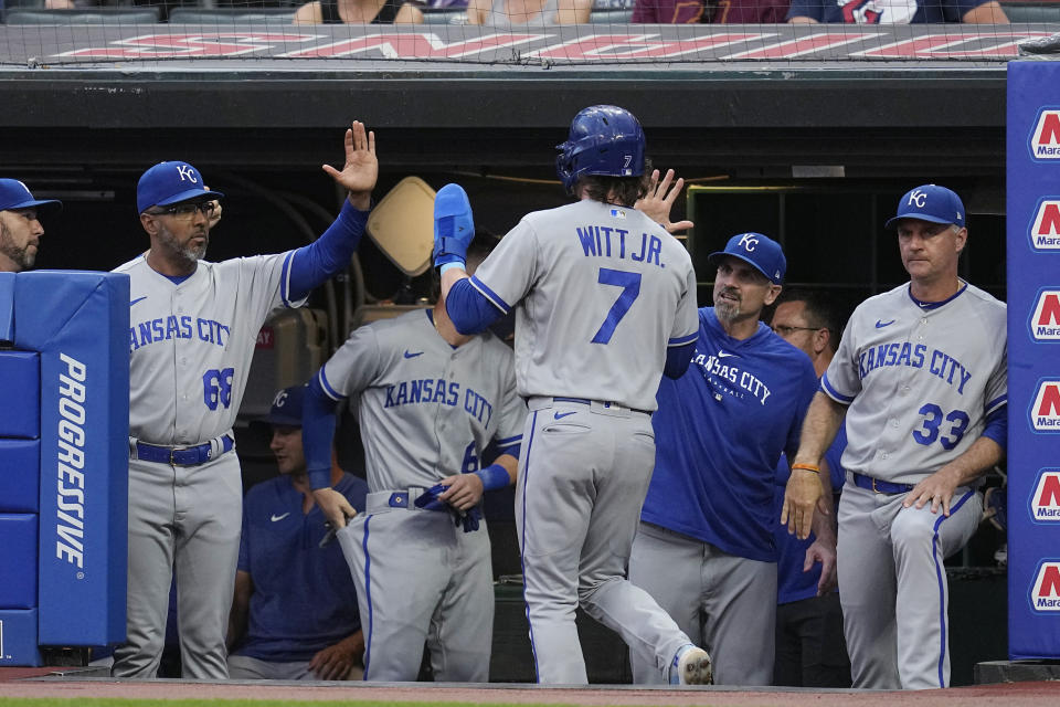 Kansas City Royals' Bobby Witt Jr. (7) is greeted in the dugout after scoring on a single by Nick Pratto against the Cleveland Guardians during the first inning of a baseball game Thursday, July 6, 2023, in Cleveland. (AP Photo/Sue Ogrocki)