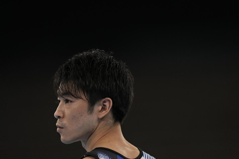 Kohei Uchimura, of Japan, watches performances during the men's artistic gymnastic qualifications at the 2020 Summer Olympics, Saturday, July 24, 2021, in Tokyo. (AP Photo/Natacha Pisarenko)