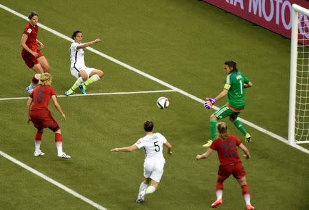 Jun 30, 2015; Montreal, Quebec, CAN; United States midfielder Carli Lloyd (10) passes to defender Kelley O'Hara (5) and O'Hara scores against Germany goalkeeper Nadine Angerer (1) during the second half of the semifinals of the FIFA 2015 Women's World Cup at Olympic Stadium. Mandatory Credit: Eric Bolte-USA TODAY Sports