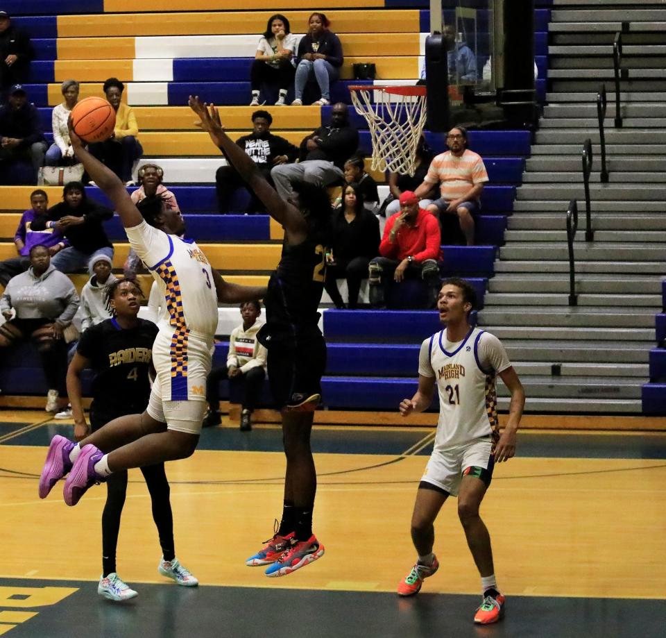 Mainland’s Narayan Thomas (3) throws down a dunk over a Rickards defender in the Region 1-5A finals on Friday, Feb. 23, 2024 at Mainland High School.