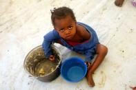 A Congolese child, whose family fled from ethnic fighting in Democratic Republic of Congo by fleeing on a boat across Lake Albert, eats a meal at United Nations High Commission for Refugees (UNHCR) reception center in Kyangwali refugee settlement camp, Uganda March 19, 2018. REUTERS/James Akena