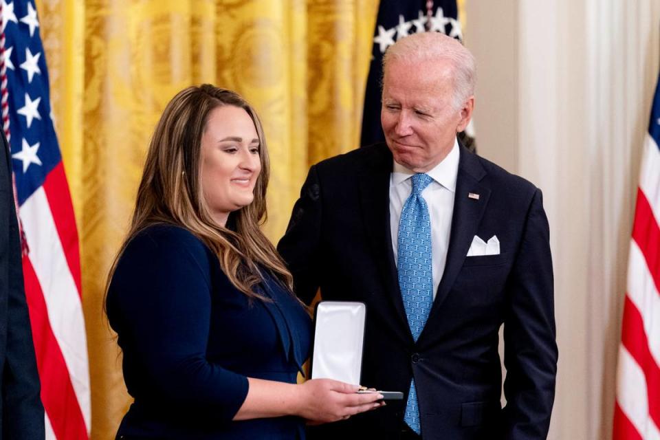 Haylee Shuping, the wife of fallen Concord, N.C., Police Officer Jason Shuping, stands with President Joe Biden as he awards her late husband the Public Safety Officer Medal of Valor in the East Room of the White House on Monday, May 16, 2022.