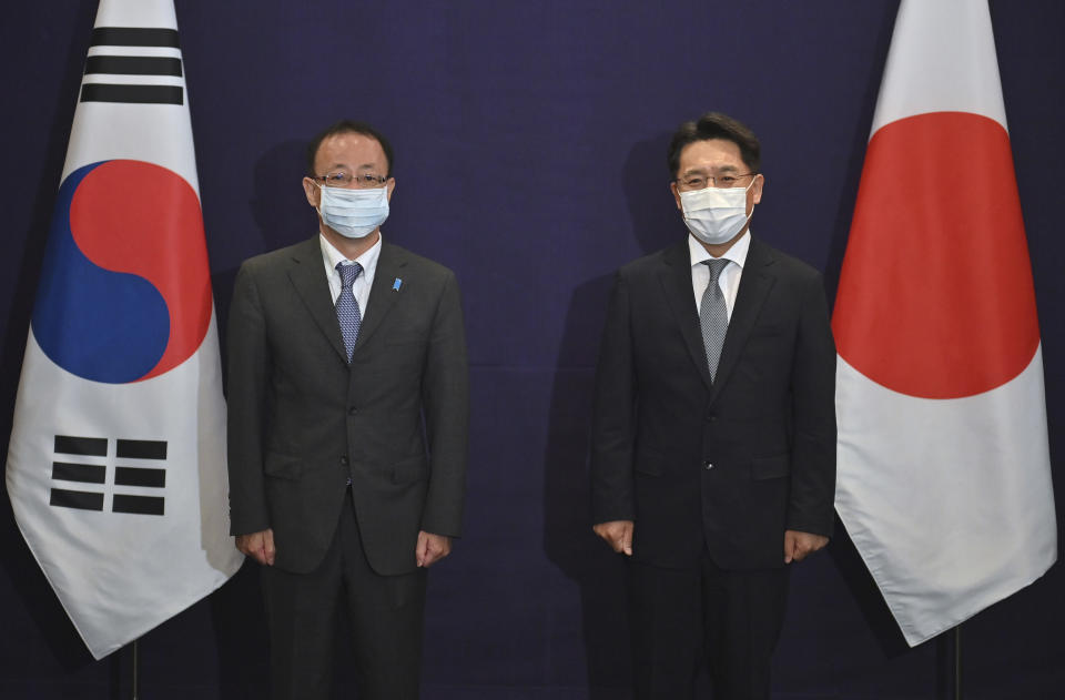 South Korea's Special Representative for Korean Peninsula Peace and Security Affairs Noh Kyu-duk, right, poses with Director-General of the Asian and Oceanian Affairs Bureau of the Ministry of Foreign Affairs of Japan Takehiro Funakoshi during their bilateral meeting at a hotel in Seoul, Monday, June 21, 2021. (Jung Yeon-Je/Pool Photo via AP)