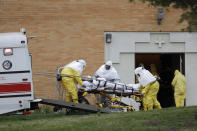 A residents from St. Joseph's Senior Home is loaded into a bus in Woodbridge, N.J., Wednesday, March 25, 2020. More than 90 residents of the nursing home in Woodbridge are being transferred to a facility in Whippany after 24 tested positive for COVID-19, according to a spokeswoman for CareOne, which operates the Whippany facility. The facility has moved its residents to other facilities to accommodate the new arrivals. (AP Photo/Seth Wenig)