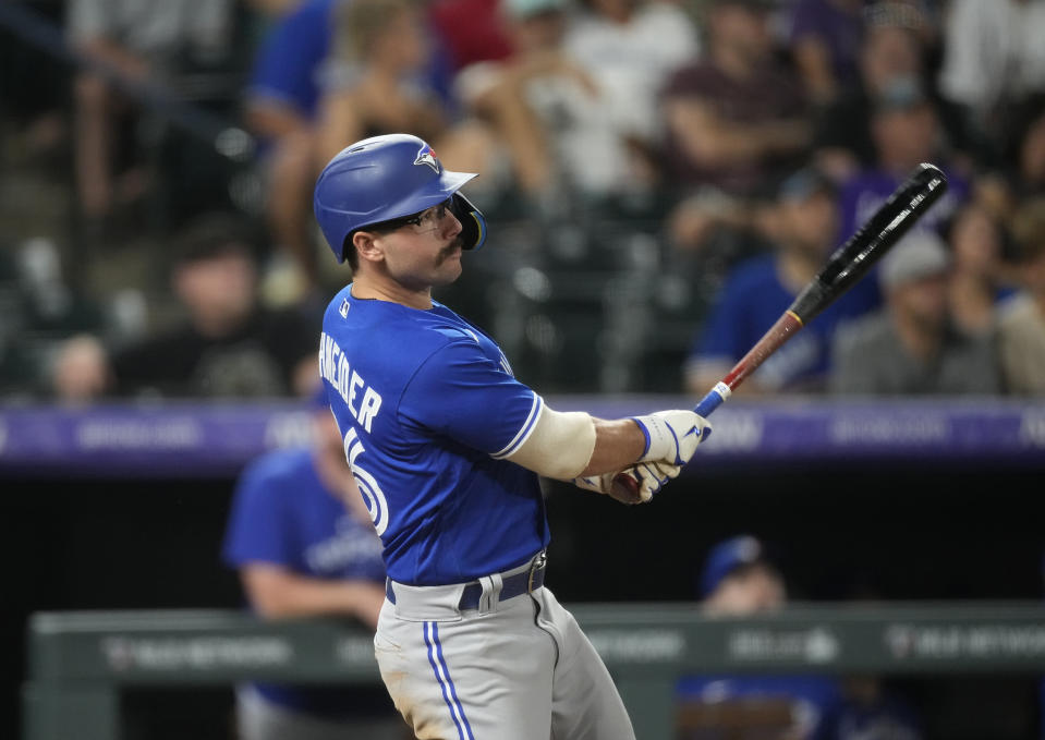 Toronto Blue Jays' Davis Schneider watches his RBI triple off Colorado Rockies relief pitcher Justin Lawrence during the ninth inning of a baseball game Saturday, Sept. 2, 2023, in Denver. (AP Photo/David Zalubowski)