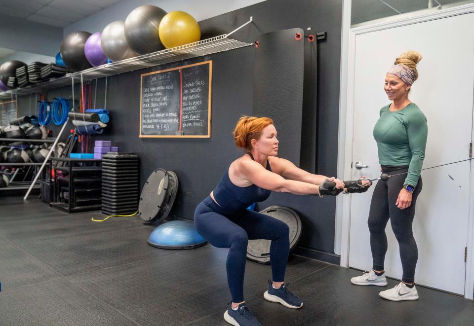 Christine Phipps, left, works out with trainer Jill Dearmin at Loggerhead Fitness in the Plaza La Mer shopping center in Juno Beach, Florida on October 25, 2023.