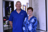 Charleen Ferguson, right, poses for a photo with her husband Jay Ferguson at their business in Wylie, Texas, Friday, July 1, 2022. Landlords were forgiving about rent during the first two years of the pandemic, but now many are asking for back due rent. The Fergusons own the building that houses the tech business they own, Just Call the I.T. Guy and also have 13 tenants, so they see the dilemma from both the small business and landlord points of view. (AP Photo/LM Otero)