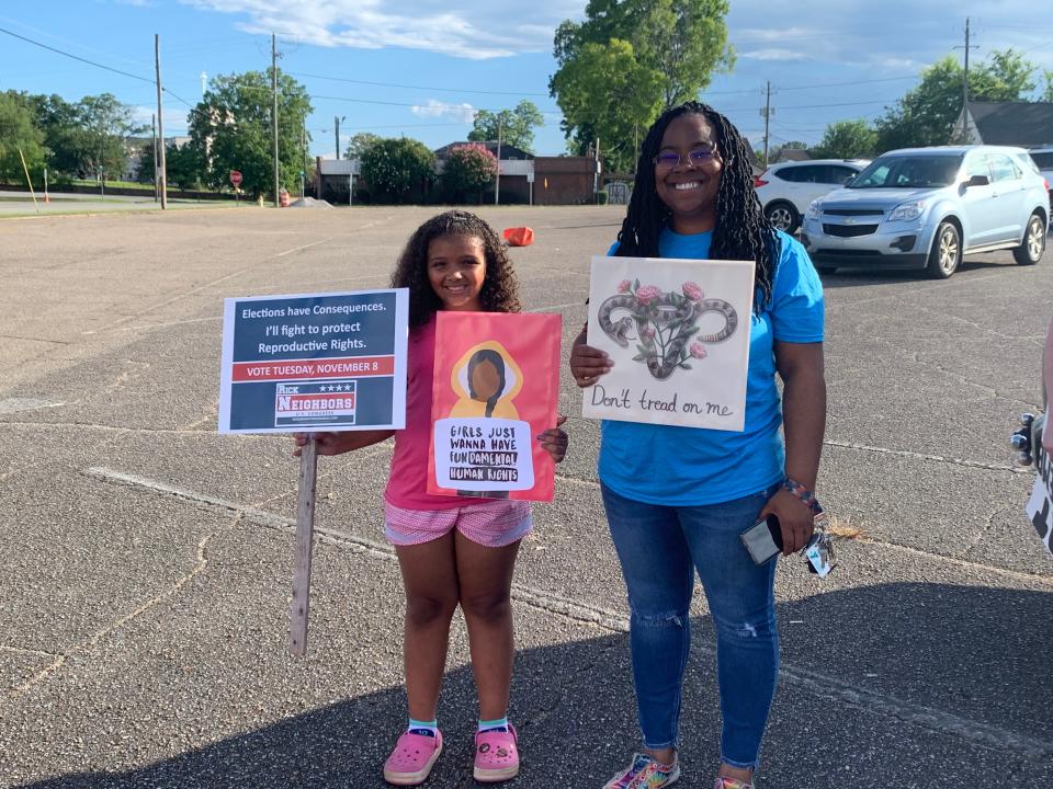 Terica West alongside her daughter with signs at the March for Women's Reproductive Rights