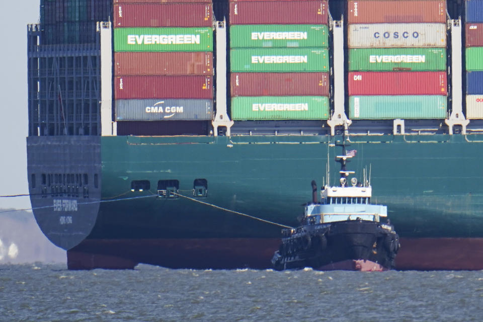 The tugboat Atlantic Salvor, bottom, uses a line to pull the container ship Ever Forward, which ran aground in the Chesapeake Bay, as crews began to attempt to refloat the ship, Tuesday, March 29, 2022, in Pasadena, Md. (AP Photo/Julio Cortez)