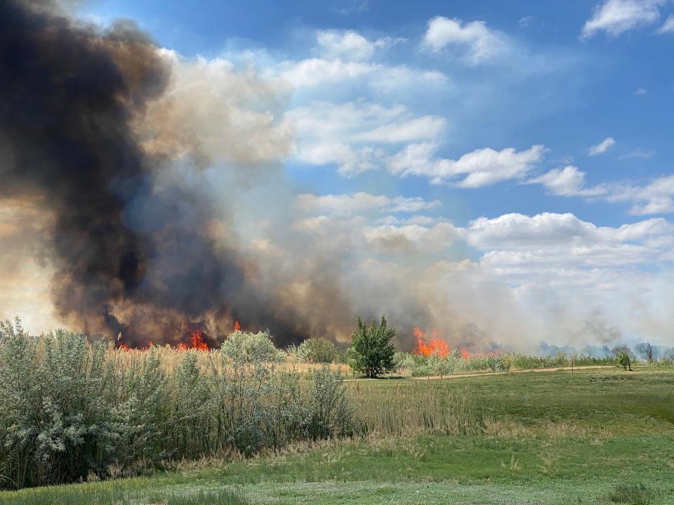 A grass fire blazes just south of Lake Minnequa on Thursday, June 2, 2022.