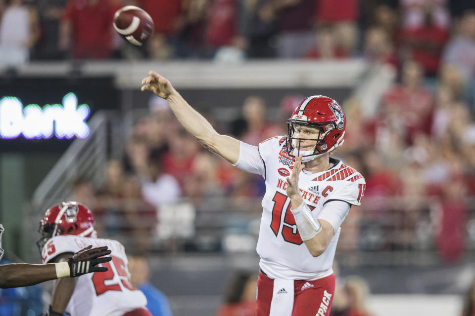 North Carolina State quarterback Ryan Finley (15) throws a pass against Texas A&M during the first half of the Gator Bowl NCAA college football game Monday, Dec. 31, 2018, in Jacksonville, Fla. (James Gilbert/The Florida Times-Union via AP)