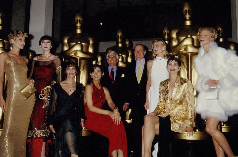 Fashion retailer Fred Hayman – center, with white hair – served as the fashion coordinator for the Oscars from 1990 to 1999. <a href="https://www.gettyimages.com/detail/news-photo/designers-contribution-to-the-66th-oscars-news-photo/529810800?adppopup=true" rel="nofollow noopener" target="_blank" data-ylk="slk:Frank Trapper/Corbis via Getty Images;elm:context_link;itc:0;sec:content-canvas" class="link ">Frank Trapper/Corbis via Getty Images</a>