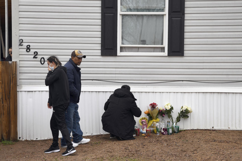 Mourners organize a memorial on Monday, May 10, 2021, outside a mobile home in Colorado Springs, Colo., where a shooting at a party Sunday took place. A shooting at a birthday party inside a trailer park home that killed six people before the gunman took his own life stunned a state weary of gun violence just weeks after another Colorado mass shooting killed 10 people. (AP Photo/Thomas Peipert)