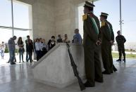 In this photo taken Wednesday, April 16, 2014, members of the Israeli and foreigner's group tour, that is organized by IPCRI, an Israeli Palestinian group promoting co-existence, visit the grave of Palestinian leader Yasser Arafat, at the West Bank city of Ramallah. This bustling center of Palestinian life is just a 20-minute drive from Jerusalem, but for Israelis it might as well be on the other side of the world. (AP Photo/Nasser Nasser)