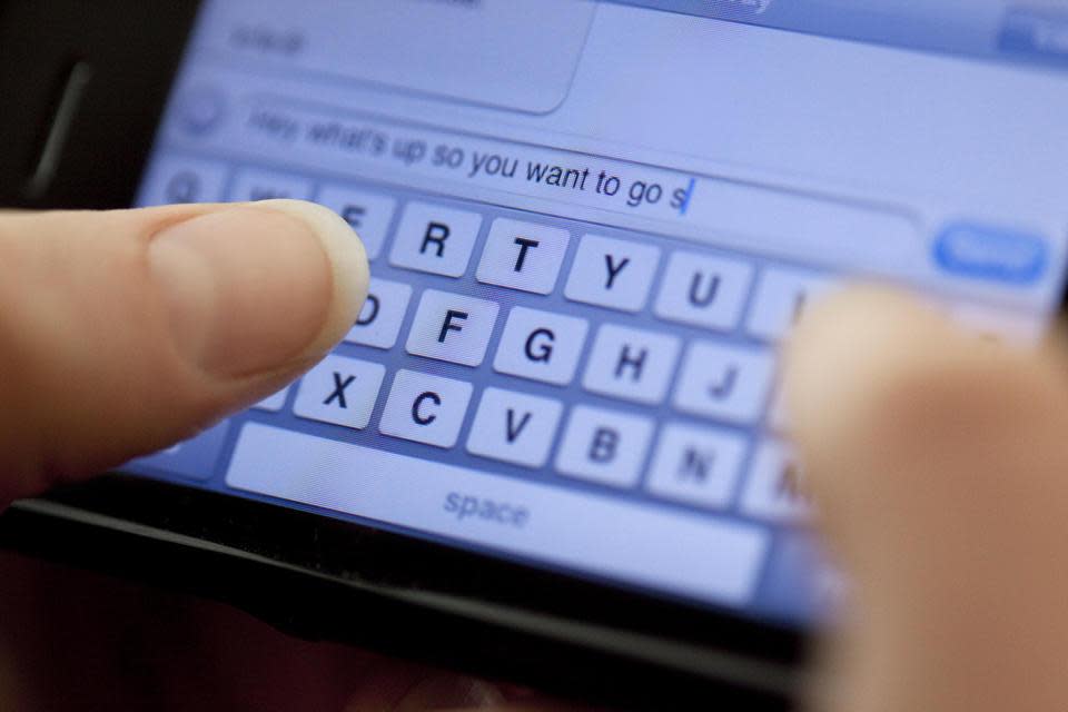 Person typing message into a smartphone