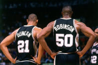 <p>2000: Tim Duncan #21 and David Robinson #50 of the San Antonio Spurs catch their breath against the Toronto Raptors during a 2000 NBA game at the Air Canada Center in Toronto, Canada.<br></p>