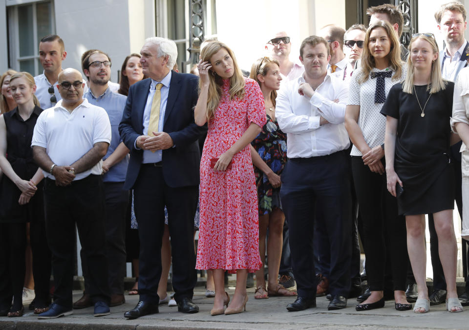 Carrie Symonds, center, the girlfriend of Britain's new Prime Minister Boris Johnson waits in 10 Downing Street, London, Wednesday, July 24, 2019. Boris Johnson has replaced Theresa May as Prime Minister, following her resignation last month after Parliament repeatedly rejected the Brexit withdrawal agreement she struck with the European Union. (AP Photo/Frank Augstein)