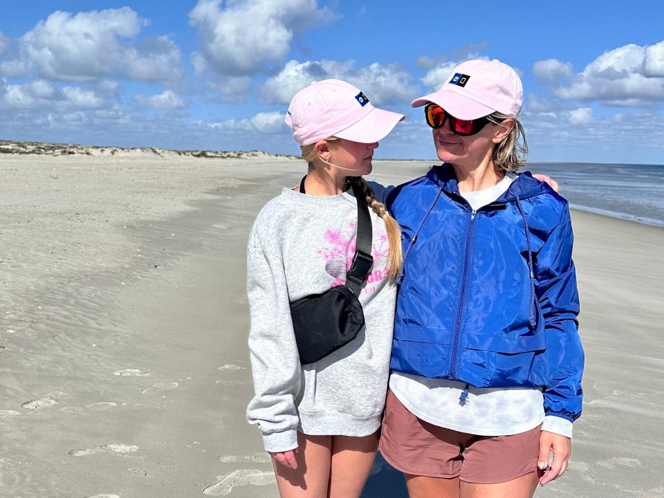 Terri Peters and her daughter on a beach.