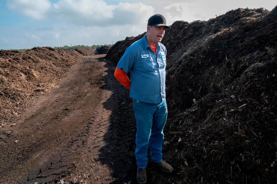 Facility supervisor Nathan Gorth stands in the rows of at the City of Modesto Compost Facility west of Modesto, Calif., on Wednesday, Nov. 17, 2021.