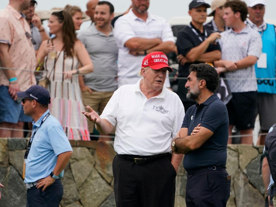 Former President Donald Trump, left, talks with Yasir Al-Rumayyan, governor of Saudi Arabia's Public Investment Fund.