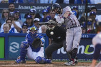 Atlanta Braves' Dansby Swanson hits an RBI single against the Los Angeles Dodgers during gate fourth inning in Game 3 of baseball's National League Championship Series Tuesday, Oct. 19, 2021, in Los Angeles. (AP Photo/Marcio Jose Sanchez)