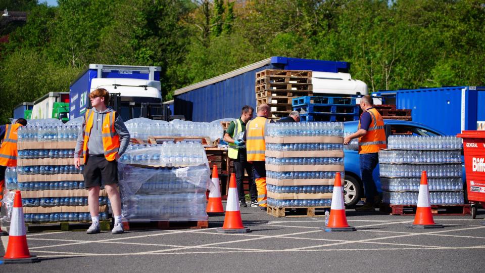 People collecting bottled water at Broadsands Car Park in Paignton
