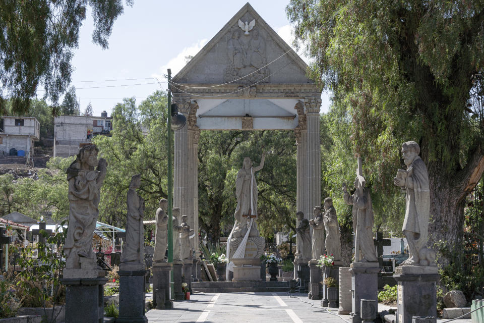 Sculptures made by the stone carvers of Chimalhuacan adorn the entrance of the cemetery in the Mexico City borough of Chilmalhuacan, once the ancient village of Xochiaca, Sunday, July 2, 2023. While carvers in other areas long ago turned to mechanical cutters and polishers, the craftsmen here use only hammers, mallets and a variety of chisels and gouges. (AP Photo/Aurea Del Rosario)