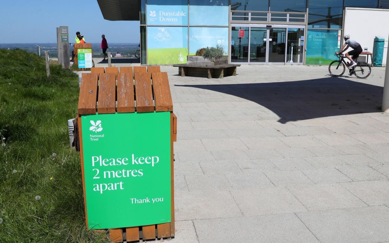 A sign at Dunstable Downs urges people to maintain a two-metre distance from each other - Catherine Ivill/Getty Images Europe