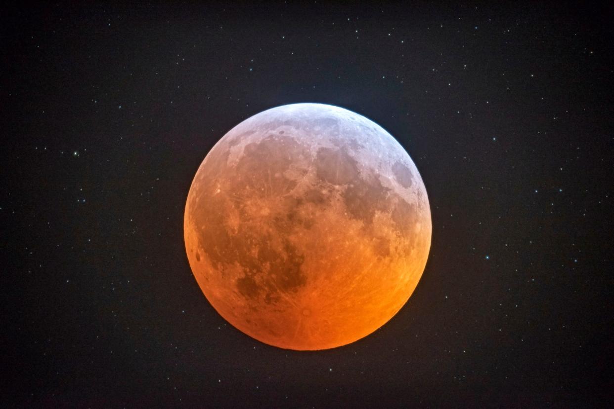 The totally eclipsed moon glows with a reddish color against the background stars in this photo made with Johnny Horne's  12-1/2 inch telescope inside his Stedman observatory early on the morning of Jan. 21, 2019. Another total lunar eclipse will happen for observers in the eastern United States late Sunday night May 15, 2022.