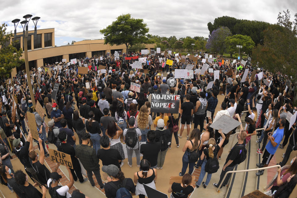 Demonstrators gather at the Simi Valley civic center during a protest, Saturday, June 6, 2020, in Simi Valley, Calif. over the death of George Floyd. Protests continue throughout the country over the death of Floyd, a black man who died after being restrained by Minneapolis police officers on May 25. (AP Photo/Mark J. Terrill)