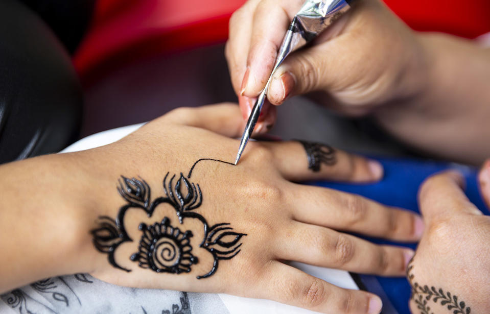 Pictured is a child getting a henna temporary tattoo, after a Perth mum warned her son was scarred after receiving a temporary tatt in Bali. 