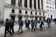 A school group walks by the New York Stock Exchange, Tuesday, Feb. 23, 2021. (AP Photo/Mark Lennihan)