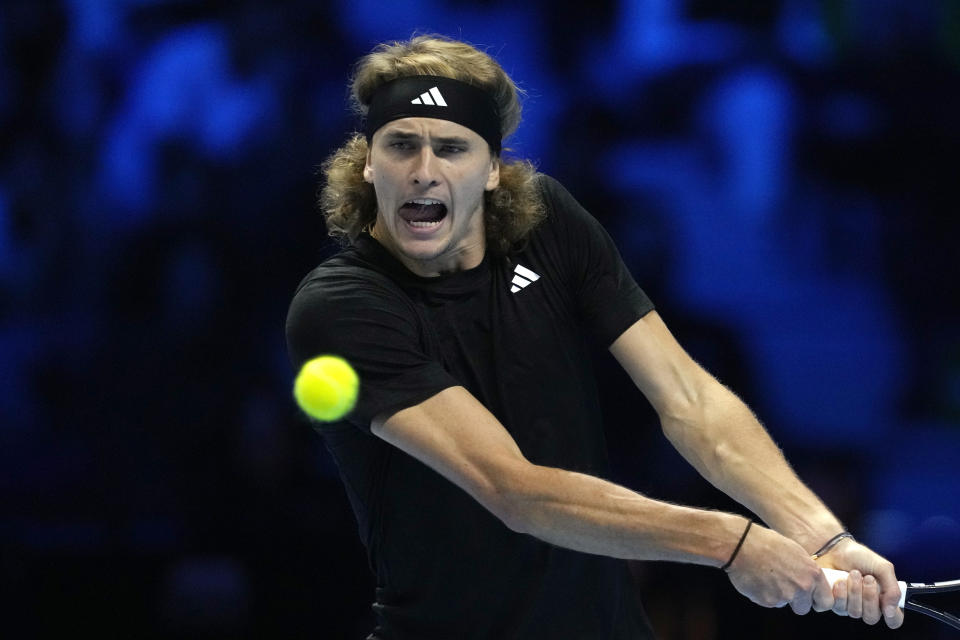 Germany's Alexander Zverev returns the ball to Spain's Carlos Alcaraz during their singles tennis match of the ATP World Tour Finals at the Pala Alpitour, in Turin, Italy, Monday, Nov. 13, 2023. (AP Photo/Antonio Calanni)