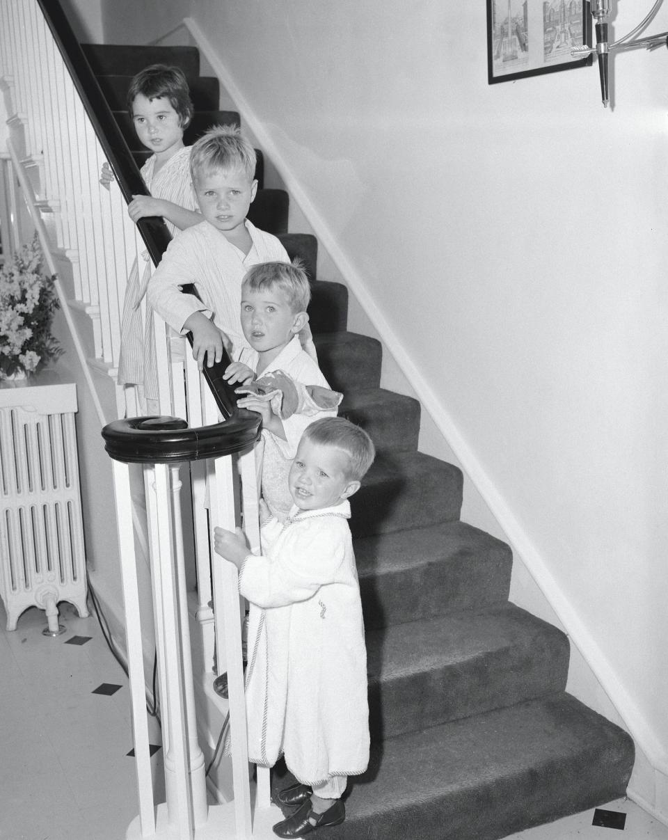 Four of Robert F. Kennedy's children pose for a photo on the stairs of the family house, Hickory Hill.
