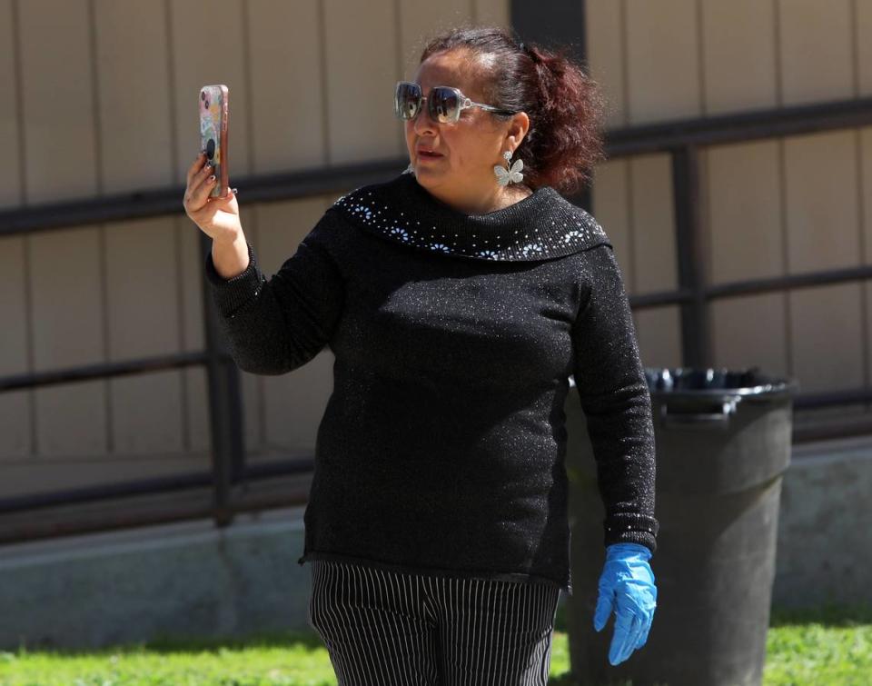 Martha Alvarado takes a video of Banda Los Carrillos during March 17 fundraiser at Mosqueda Park in Fresno.