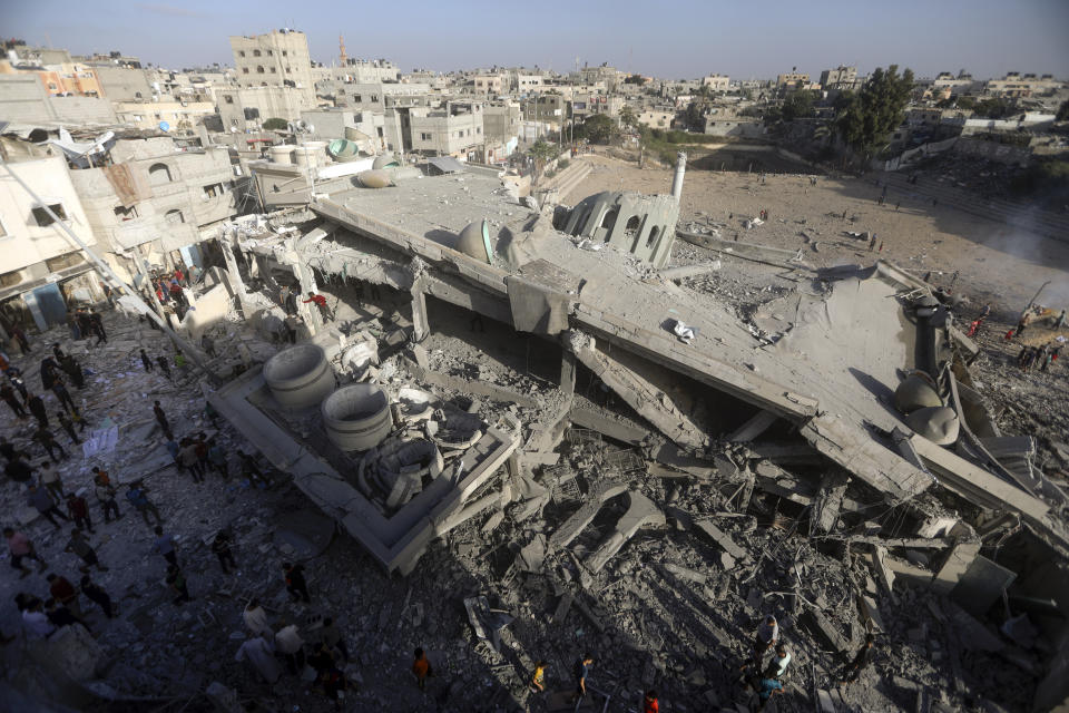 Palestinians inspect the damage of a destroyed mosque following an Israeli airstrike in Khan Younis refugee camp, southern Gaza Strip, Wednesday, Nov. 8, 2023. (AP Photo/Mohammed Dahman)