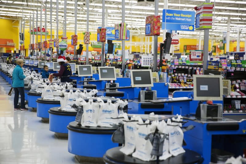 FILE PHOTO: Employees work at the checkout counters of a Walmart store in Secaucus, New Jersey
