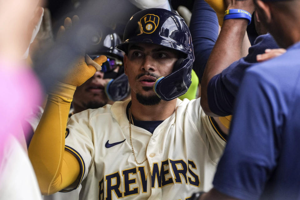 Milwaukee Brewers' Willy Adames celebrates in the dugout after hitting a home run in the seventh inning of a baseball game against the Tampa Bay Rays, Wednesday, May 1, 2024, in Milwaukee. (AP Photo/Kenny Yoo)