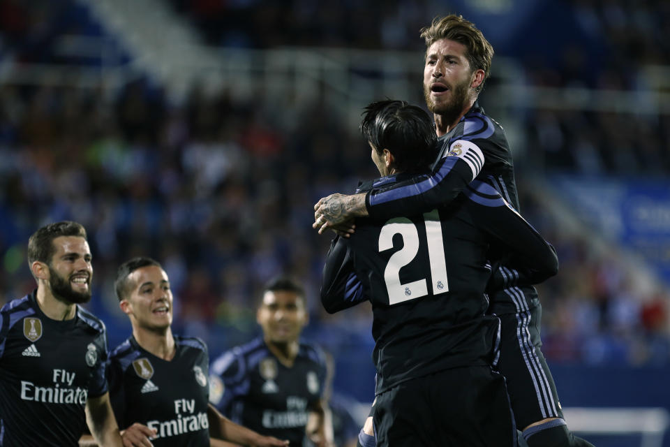 Real Madrid's Alvaro Morata, second right, celebrates with teammates Sergio Ramos, top, Jose Luis Fernandez "Nacho", left, and Lucas Vazquez, second left, their side's second goal against Leganes during a Spanish La Liga soccer match between Leganes and Real Madrid at the Butarque stadium in Madrid, Wednesday, April 5, 2017. (AP Photo/Francisco Seco)